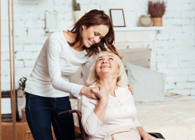 caregiver and elderly woman laughing