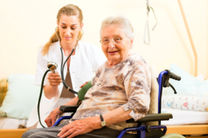 nurse checking the blood pressure of a senior