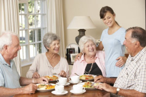 group of old people eating breakfast together
