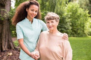 smiling old woman and her caregiver