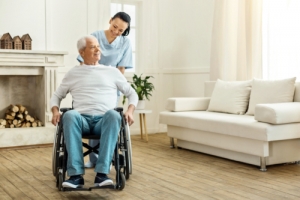 old man in a wheelchair and his caregiver